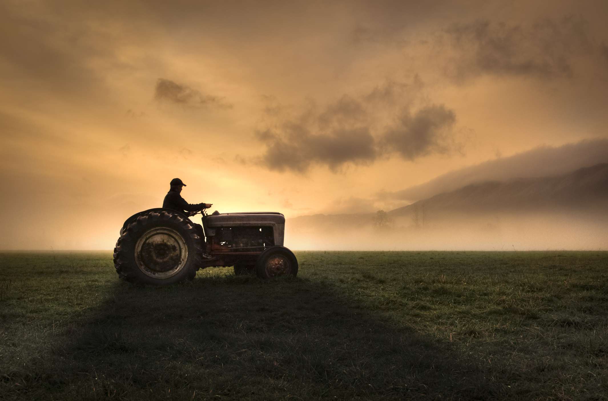 Farmer riding tractor