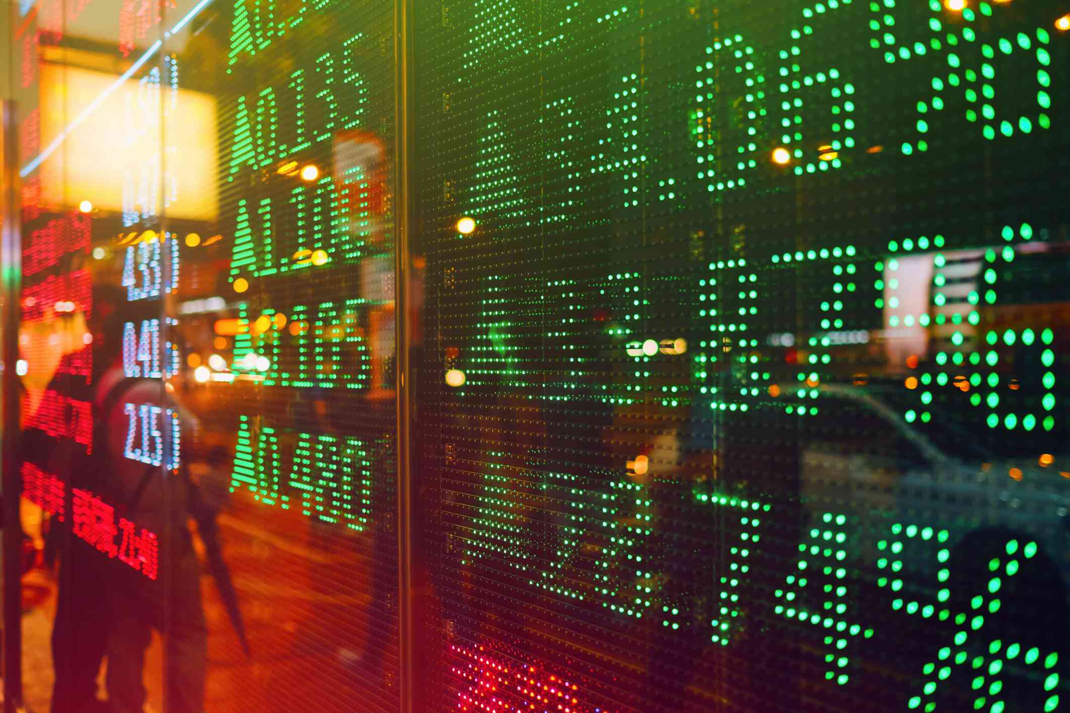 Stock exchange market display screen board on the street showing stock rises in green color.