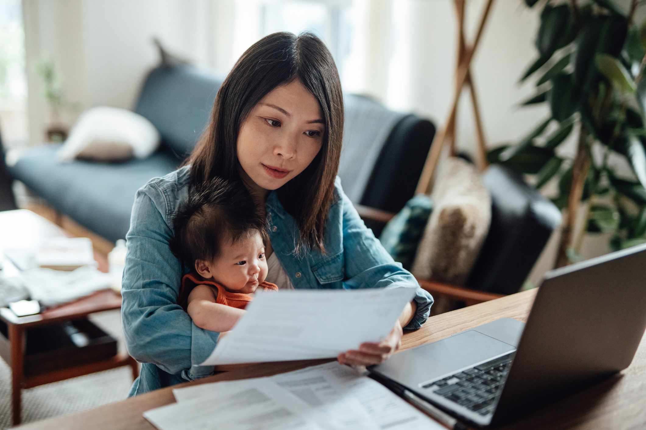 Person with baby looking at account statement