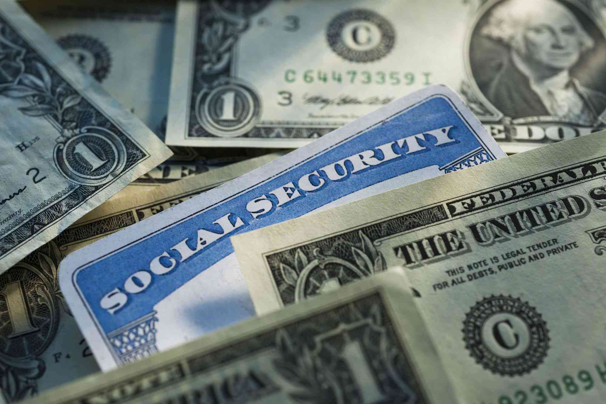 Social Security card surrounded by cash, representing tax on Social Security payments.