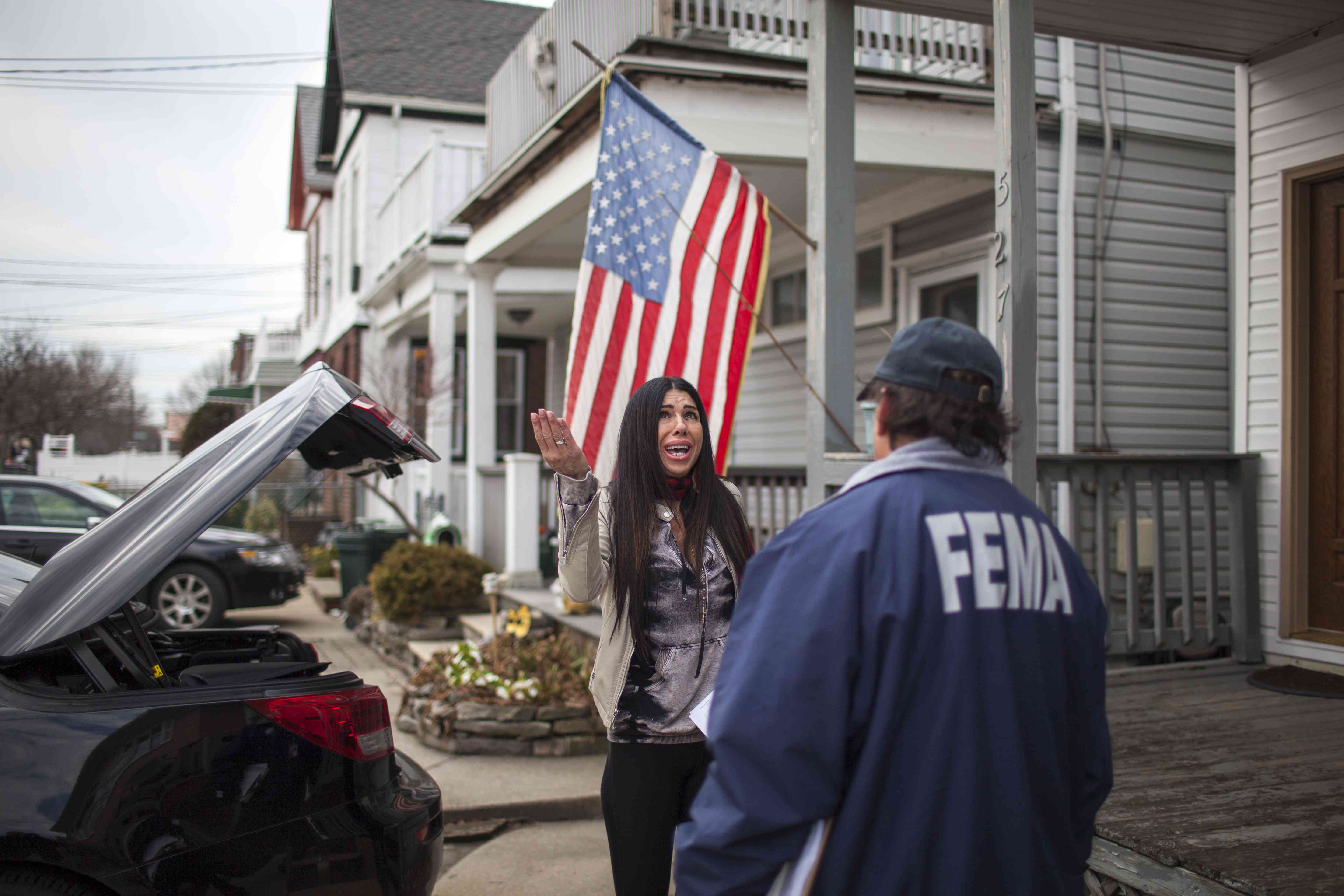 Federal Emergency Management Agency (FEMA) representative with resident affected by Hurricane Sandy in Queens, N.Y., in January 2013