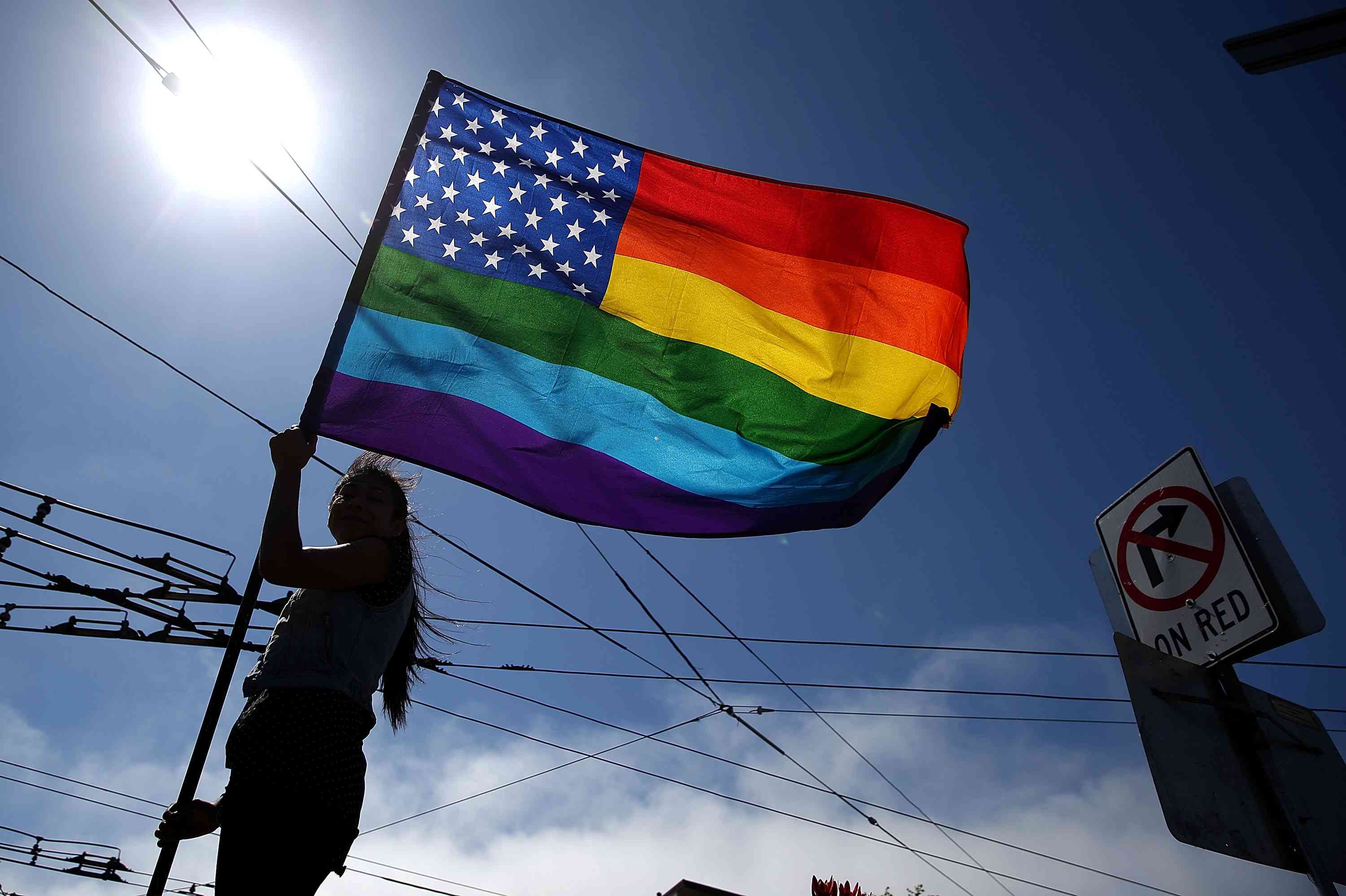 same-sex marriage supporter waves a pride flag