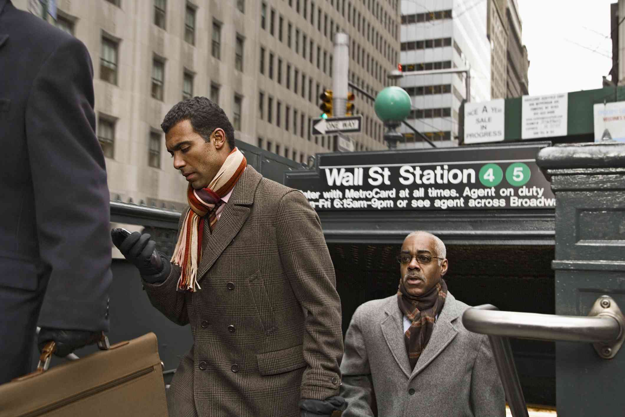 Businesspeople exiting the Wall Street subway station in New York City 