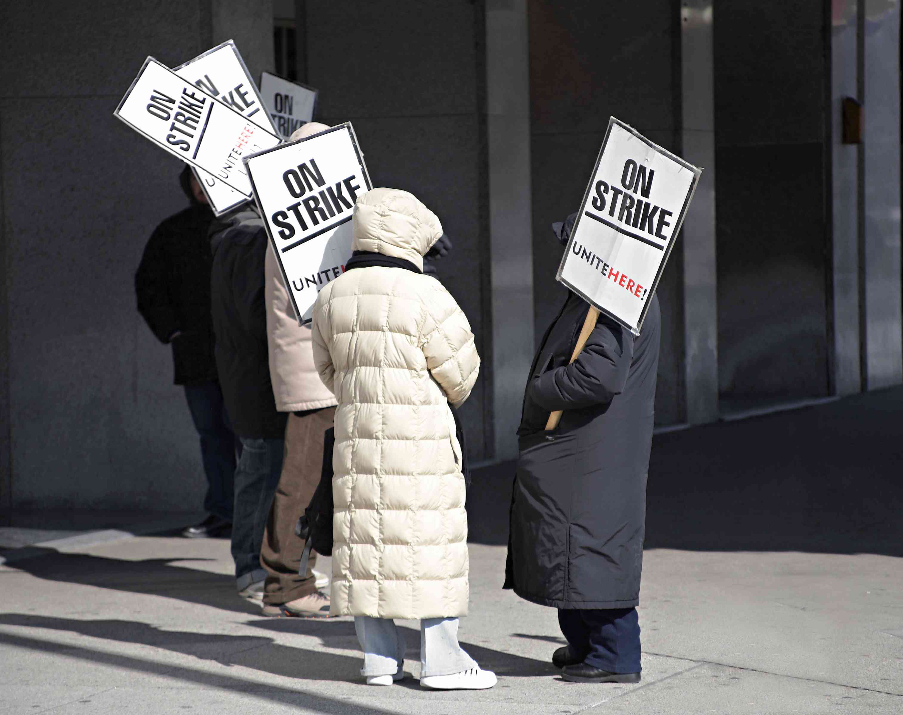 A group of union workers on strike is an indication of organized labor practices.