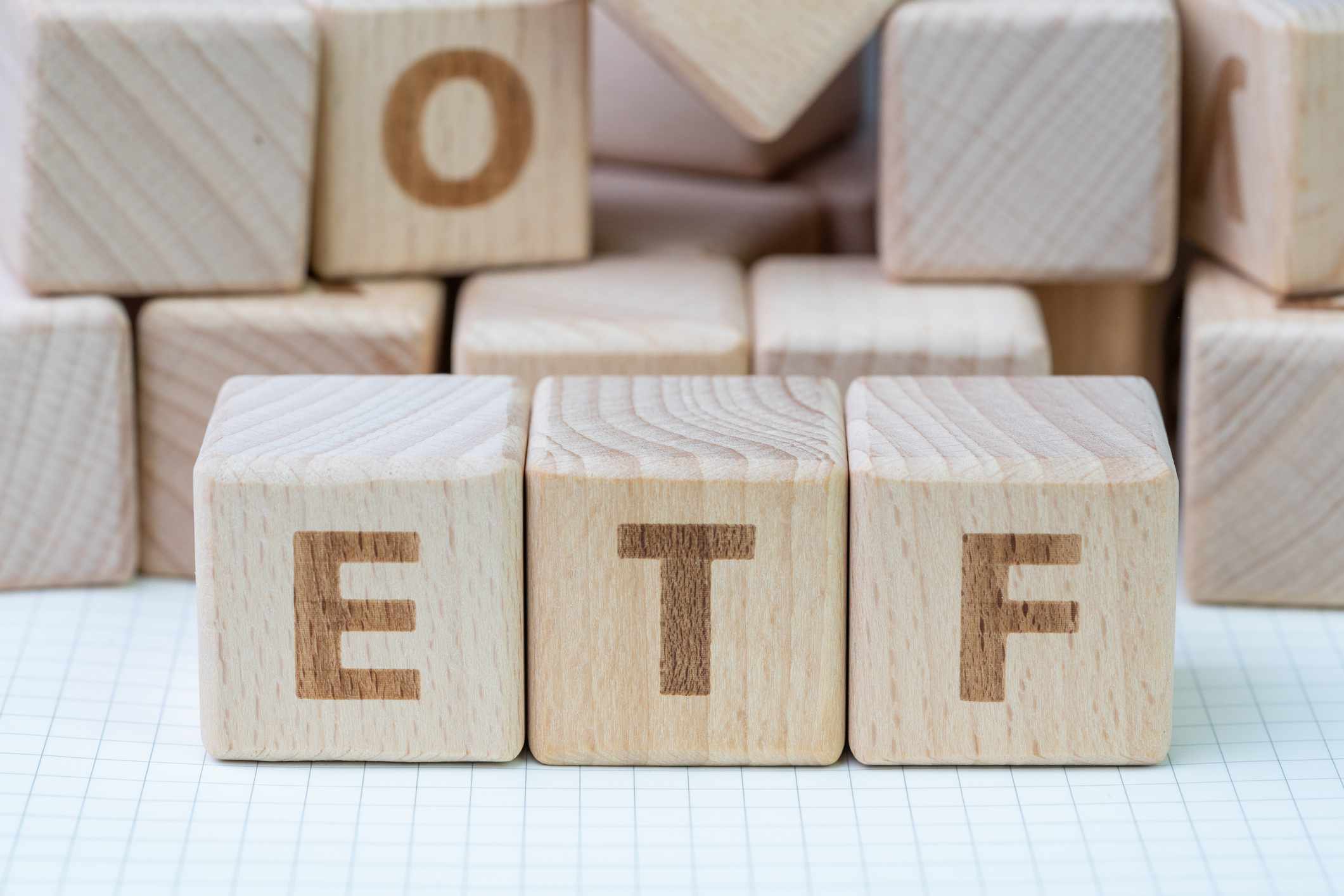 Cube wooden blocks with alphabet building the word ETF.
