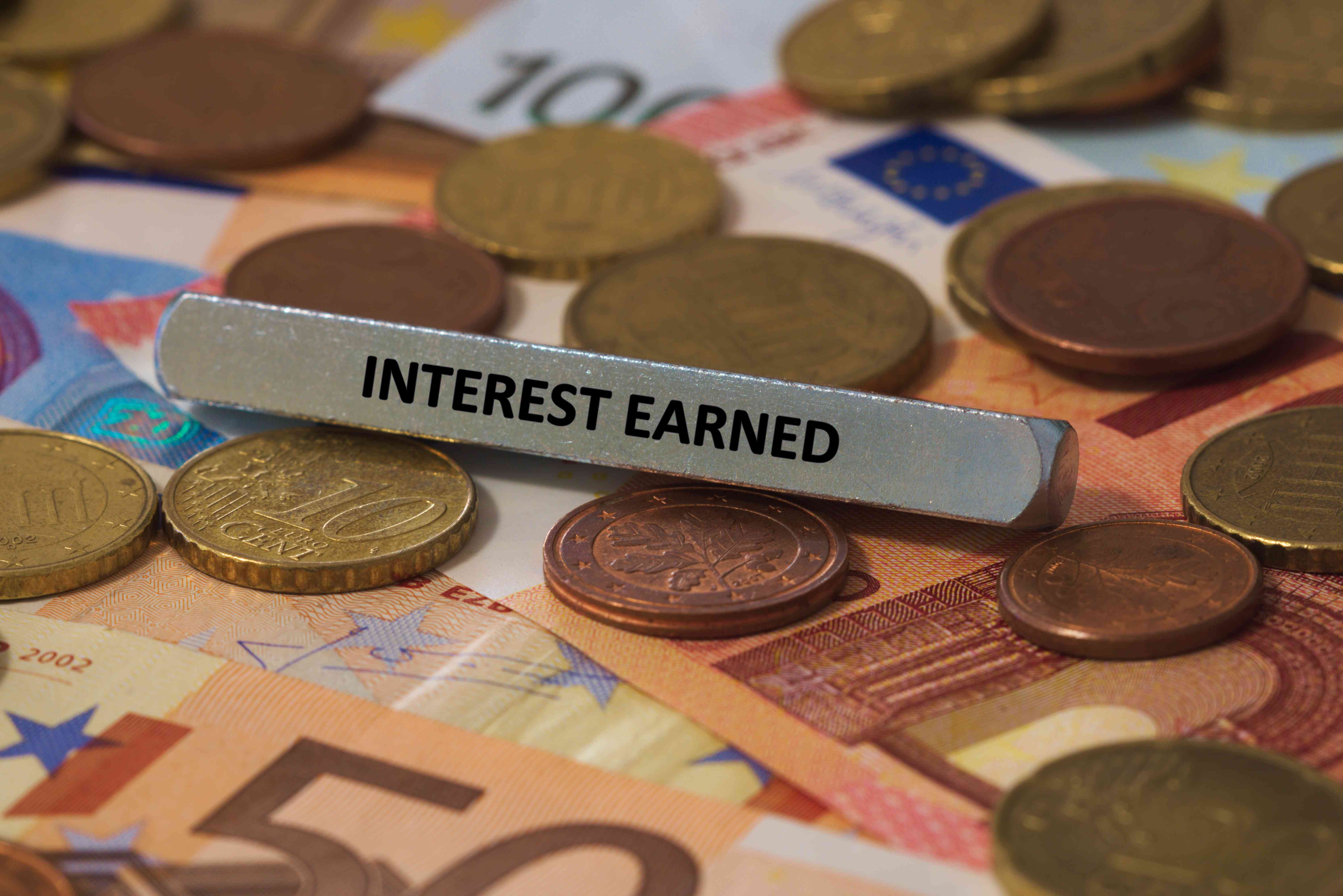 interest earned - the word was printed on a metal bar. the metal bar was placed on several banknotes