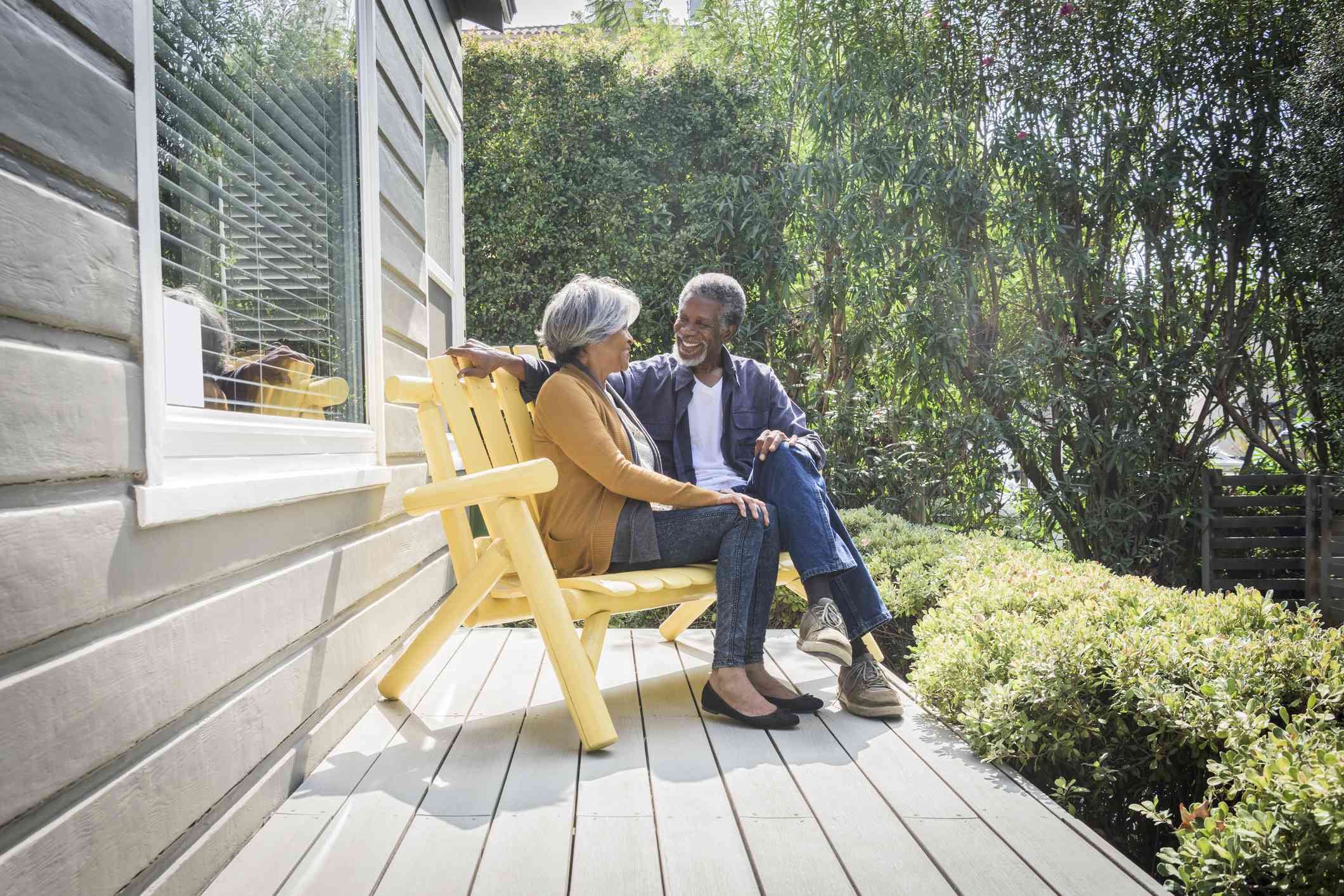 Senior retired couple sitting on front porch