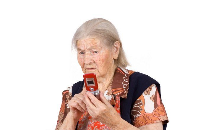 Older woman using a flip phone.