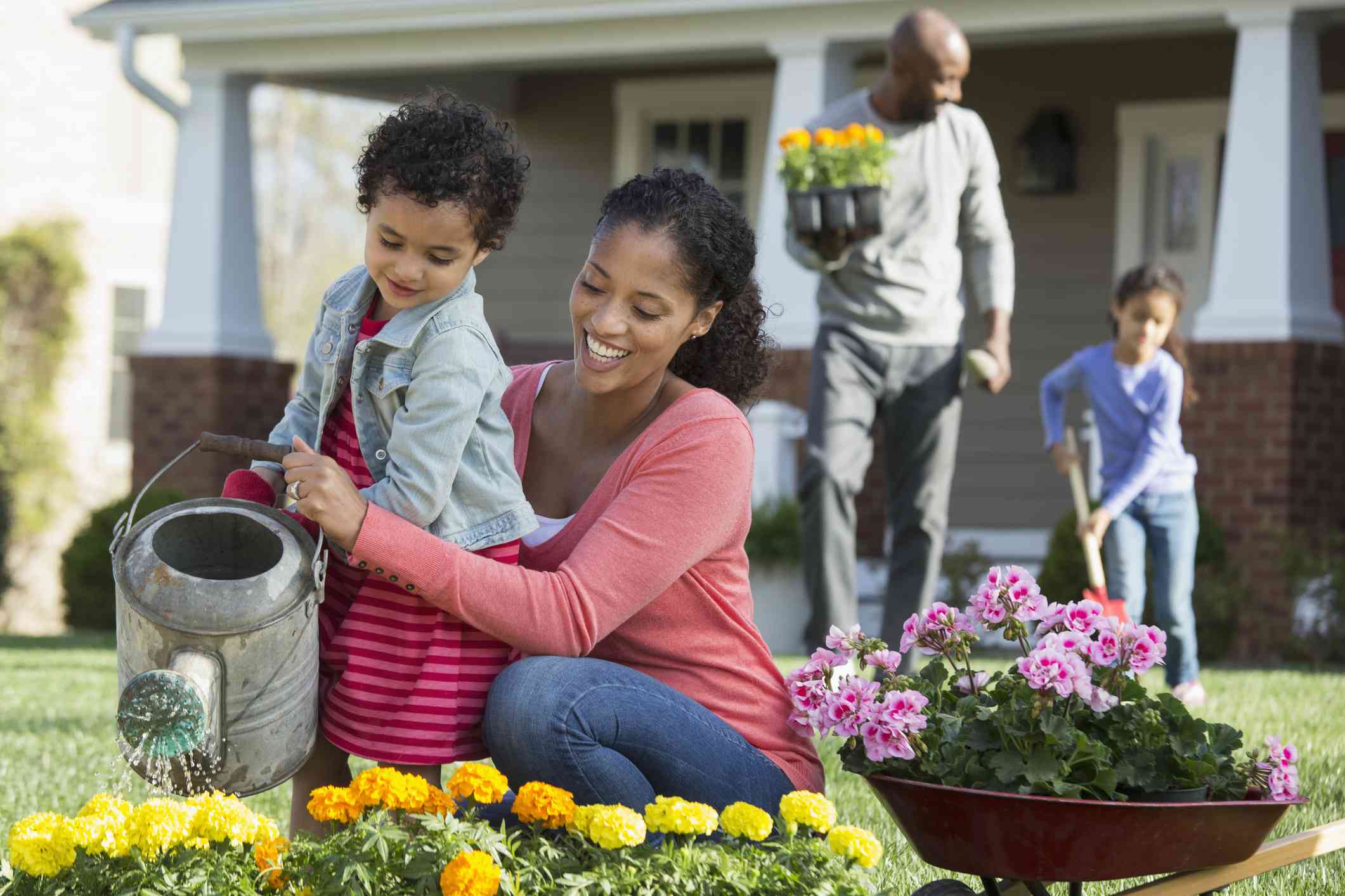 Family with two children gardening together